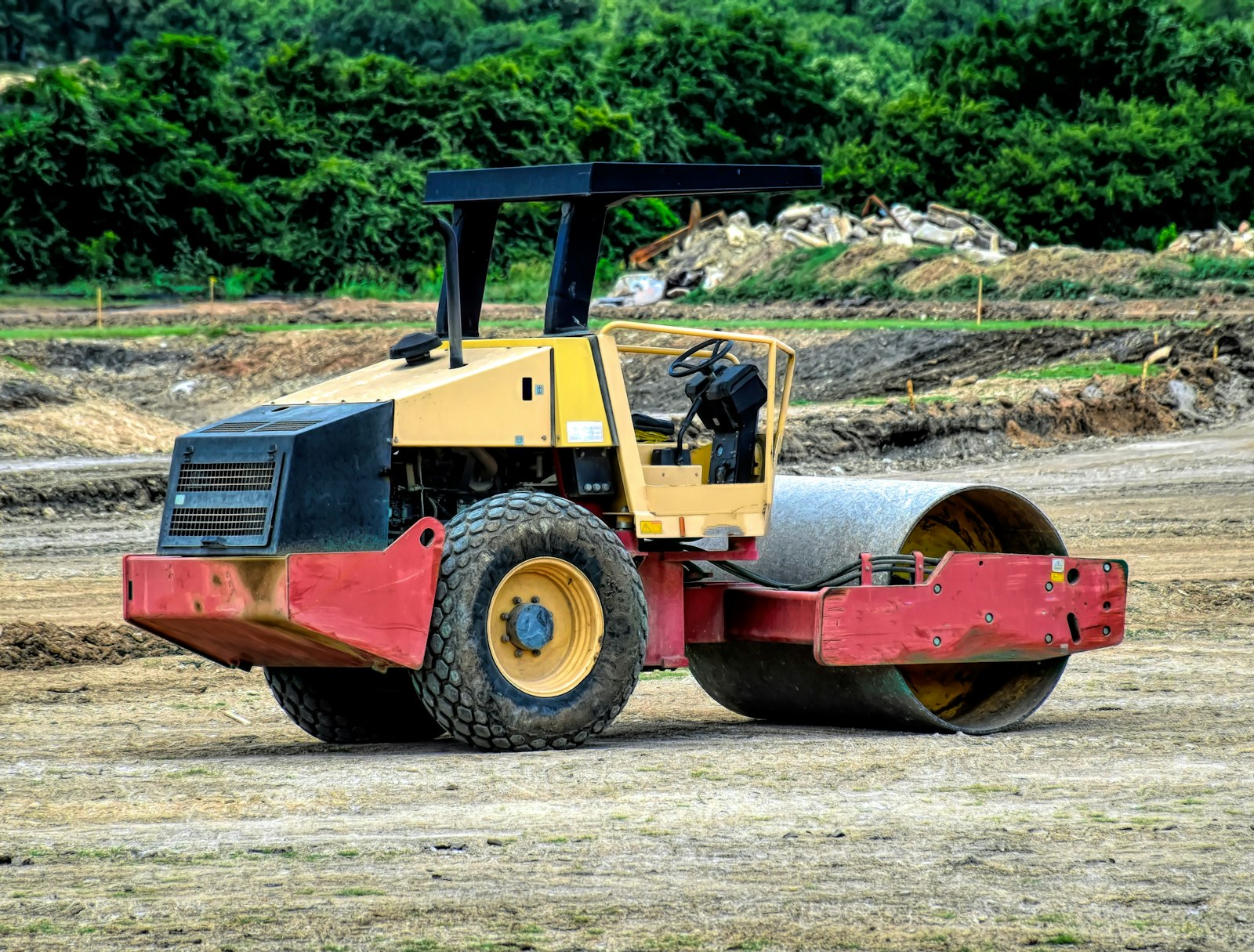 Tandem vibratory roller compacting asphalt